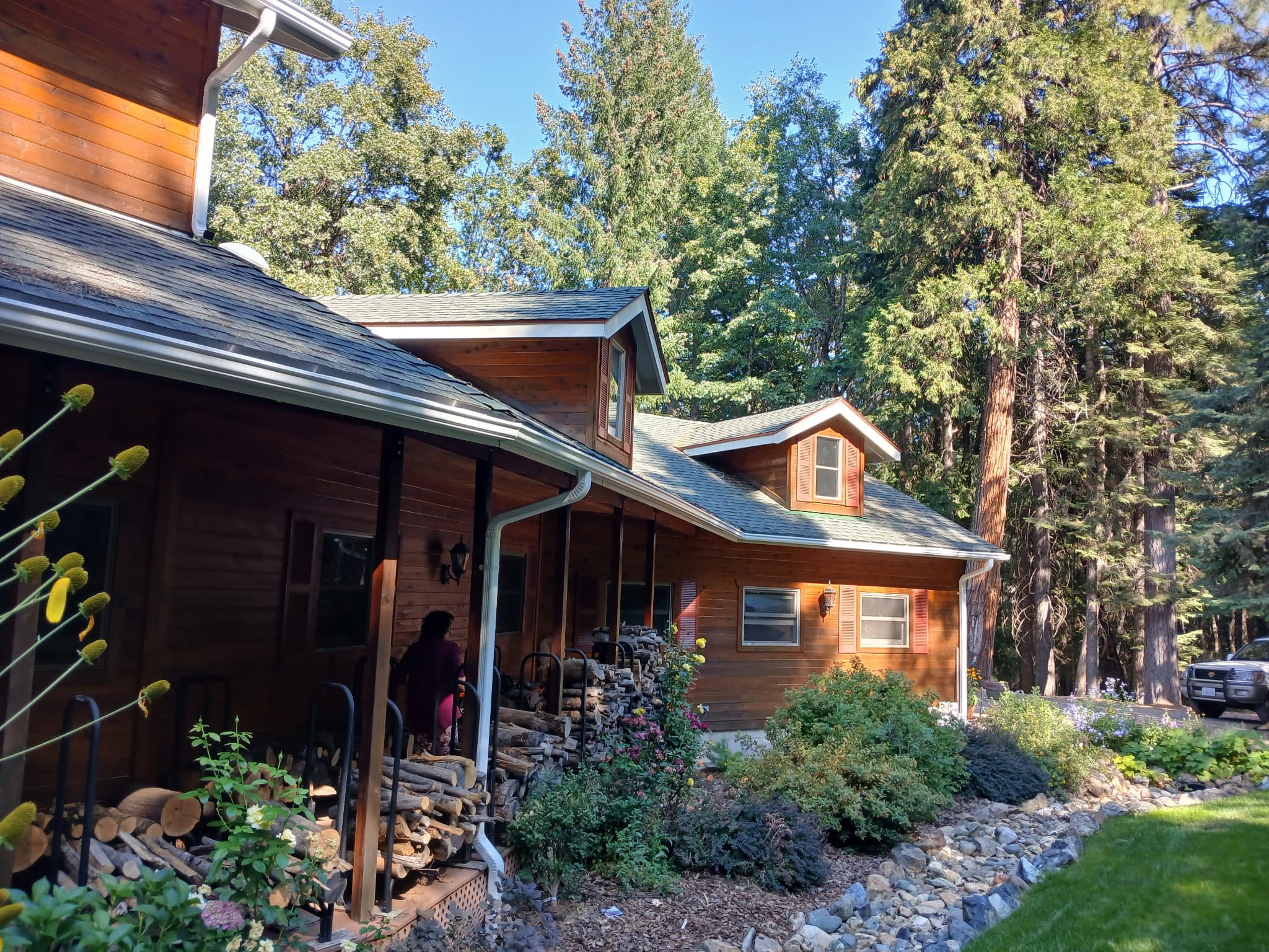 Cedar-sided cabin in the pines with new seamless gutters in Whitmore